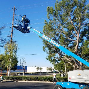 A person high up in the air operating a mobile elevated work platform