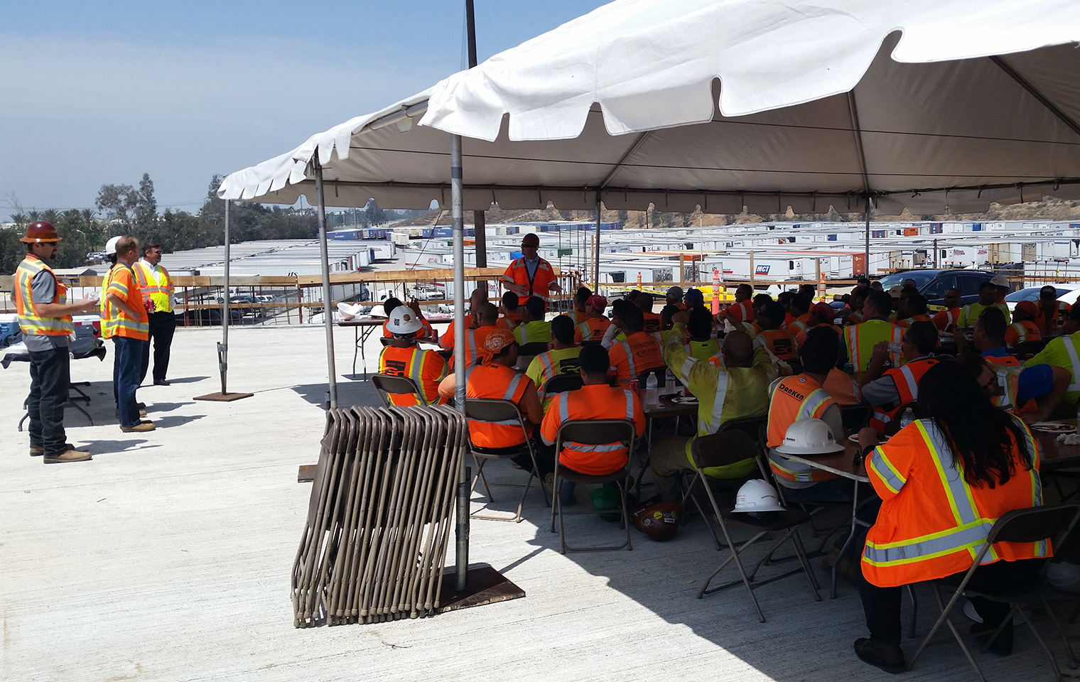 A large group of people in high visibility vests participating in a training event